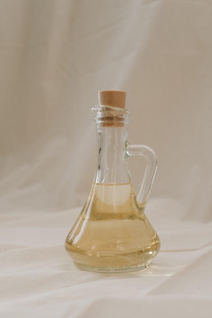 A stylish glass bottle filled with olive oil, showcasing elegance and sustainability.